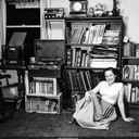 Norma with radio, record player, and reel-to-reel tape collection. Oakland, California c.1954-55.