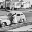 Norma with Packard automobile, outside house on Dwight Way, Berkeley.